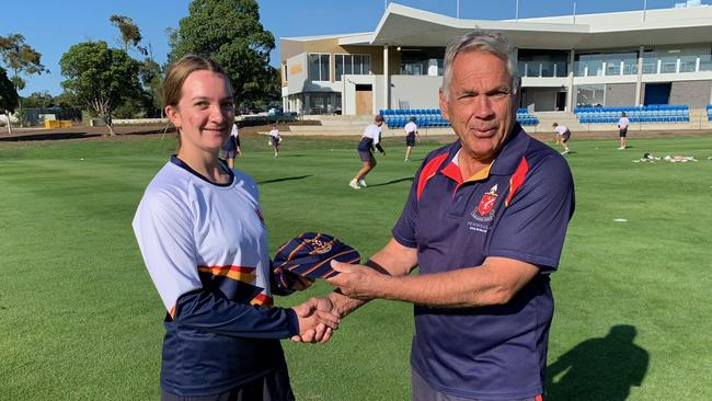 Misha Campbell receives her First XI cap from Peninsula Grammar School coach Barry Neivandt.