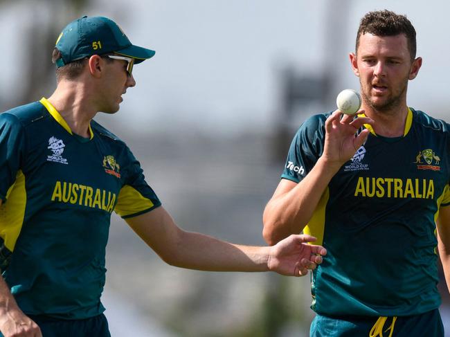 Australia's Josh Hazlewood (R) and teammate Pat Cummins during the ICC men's Twenty20 World Cup 2024 group B cricket match between Australia and England at Kensington Oval in Bridgetown, Barbados, on June 8, 2024. (Photo by Randy Brooks / AFP)