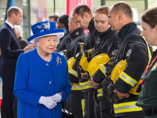 Queen Elizabeth II meets firefighters and paramedics during a visit to the Westway Sports Centre which is providing temporary shelter for those who have been made homeless in the disaster. Picture: Getty