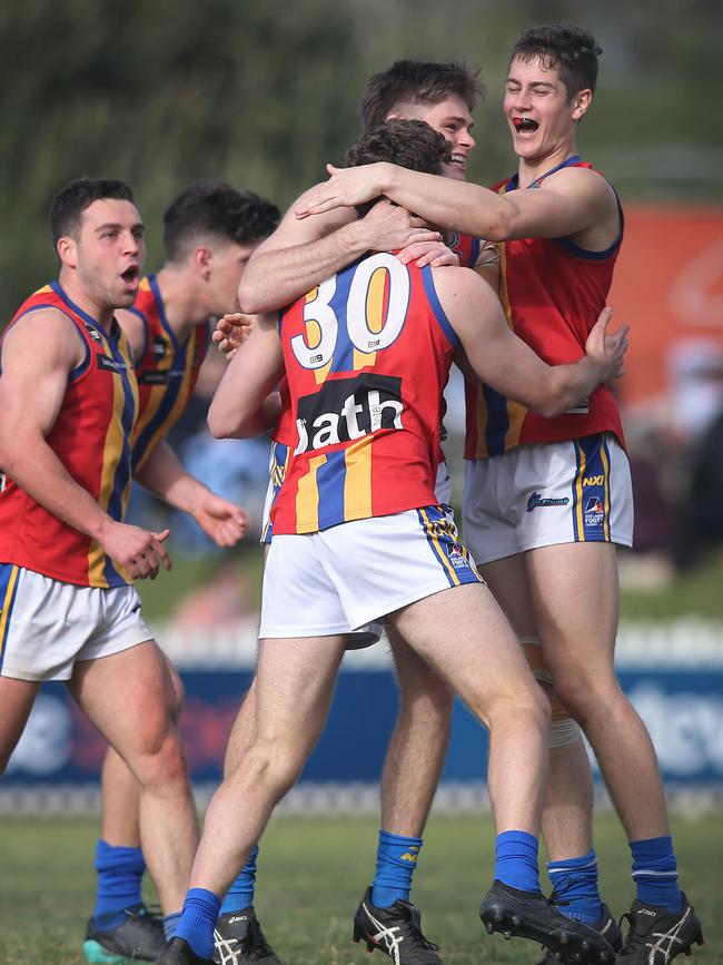 Old Ignatians players celebrate during their division two grand final win last month, which won the club promotion to the top flight. Picture: Dean Martin