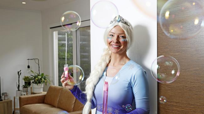 Kath Solly, dressed as Elsa from the movie Frozen, works as a children's entertainer on weekends. Picture: Toby Zerna