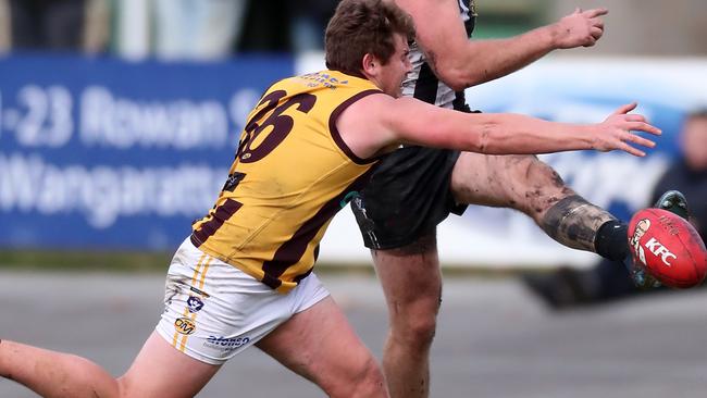 Wangaratta Rovers player Alex McCarthy tries to smother the ball. Picture Yuri Kouzmin