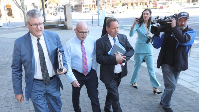 Magistrate Bob Harrap arrives at court, flanked by defence lawyers Craig Caldicott and David Edwardson QC. Picture: Tait Schmaal