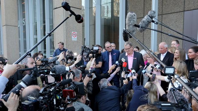 Lynette Dawson’s brother Greg Simms, flanked by journalist Hedley Thomas and Mr Simms’ wife Merilyn, outside court shortly after Chris Dawson was found guilty. Picture: NCA NewsWire / Damian Shaw