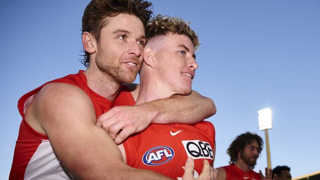 Dane Rampe of the Swans embraces Chad Warner. Photo by Brett Hemmings/AFL Photos/via Getty Images.