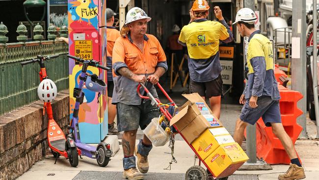 Workers at the Cbus 443 Queen St in Brisbane on Wednesday.