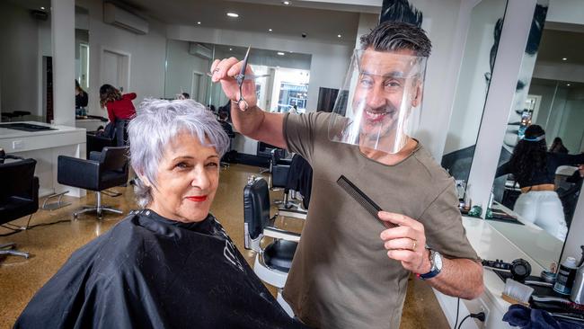 Cocca Hair Salon owner Donato Cocca wears the Rapid Shield while cutting Nella Loft’s hair. Picture: Jake Nowakowski