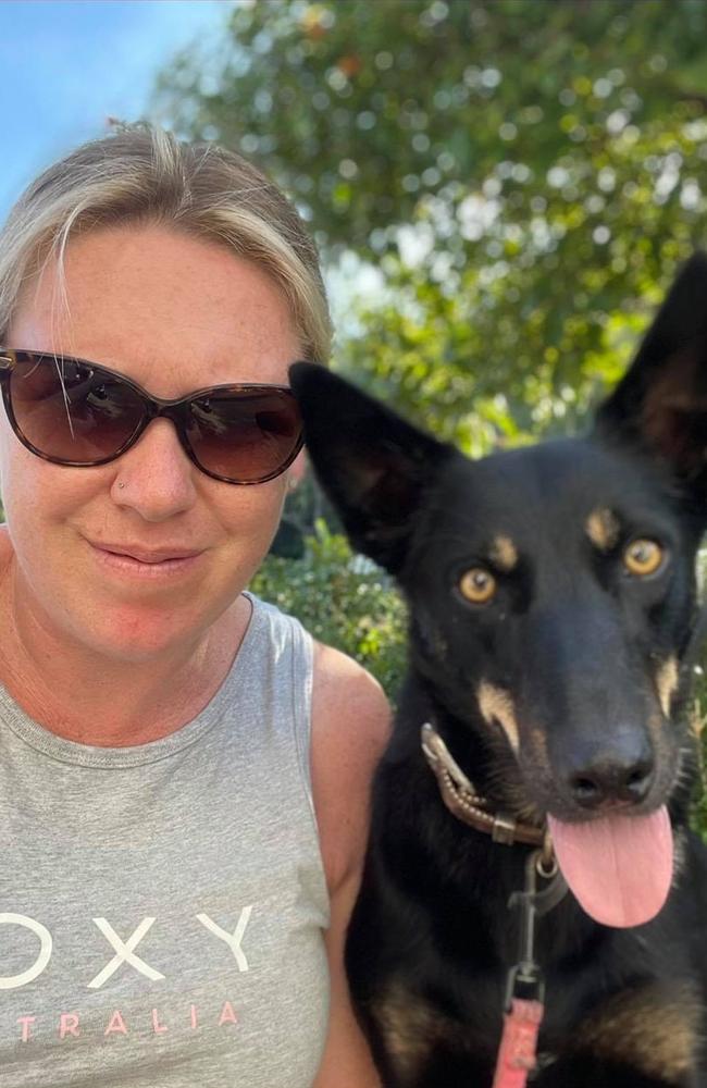 Lee-Anne Hewett of Trinity Beach with Penny, one of her two kelpies. She came across two file snakes mating in a rare sighting on a beach in Yorkeys Knob. Picture: Lee-Anne Hewett