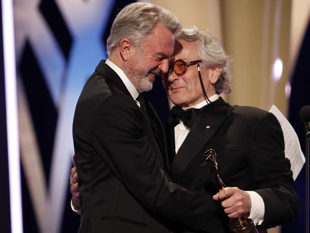 Sam Neill accepts the Longford Lyell Award from George Miller with a warm embrace at the 2019 AACTA Awards at The Star on Wednesday. Picture: Brent Lewin/Getty