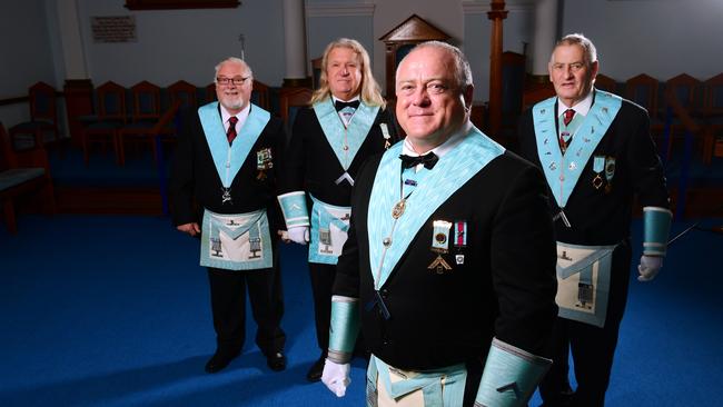 Craig Mitchell (centre) with Master of Ceremonies Darryl Jones and Worshipful Masters Robert Jennings and Jim Greenfield. Picture: AAP/Mark Brake