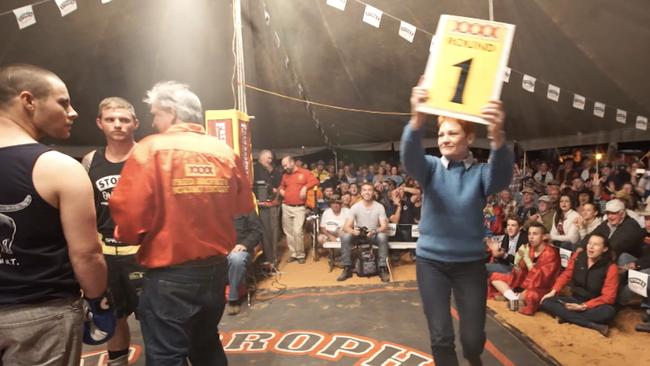 Pauline Hanson as a ring card girl in Brophy’s boxing tent in Birdsville. Picture: Supplied