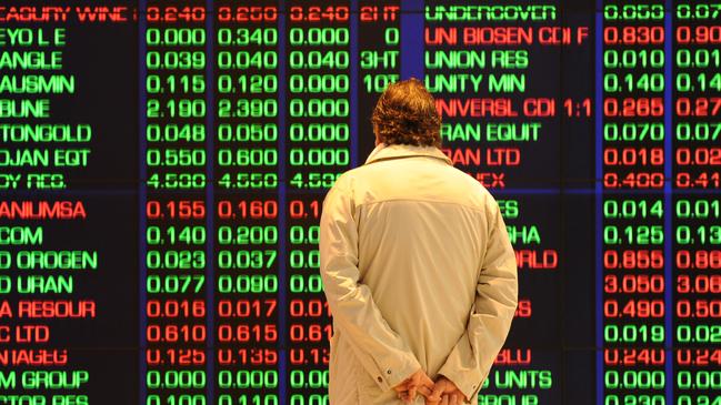 YOUR MONEY : An investor watches the share price monitors at the Australian Stock Exchange (ASX) in Sydney on August 19, 2011. Australian stocks slumped 2.75 percent following steep falls on international markets amid new worries that Europe and the US are sinking into recession.  AFP PHOTO / Torsten BLACKWOOD