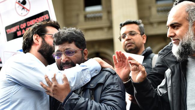 MELBOURNE, AUSTRALIA - APRIL 16TH, 2023: Amil Vemula weeps on the steps of Parliament as Victims of Porter David collapse protest at Parliament House, Melbourne. Picture : Nicki Connolly