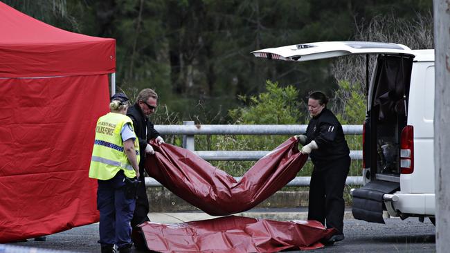 The bodies of the teenagers being removed from the crime scene where a fatal car crash occurred in Bossley Park. Picture: Adam Yip/ Second Story