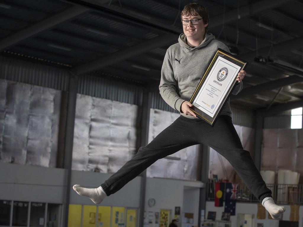 Jumping for joy: James holds the framed certificate confirming his achievement from the Guinness Book of World Records. Picture: Chris Kidd