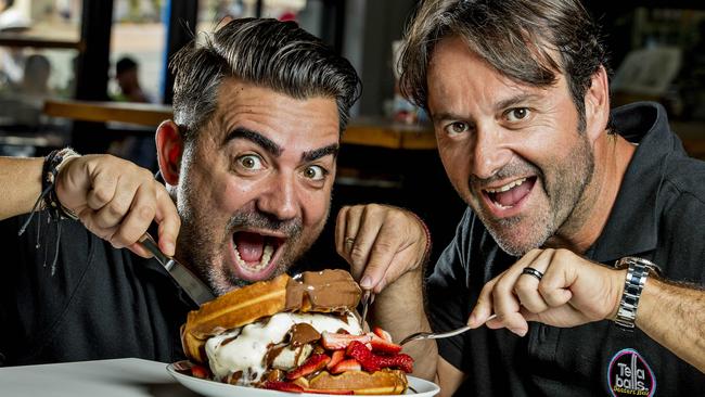 Tella Balls owners Aki Daikos and Simon Kappatos tuck into a Waffle Burger. Picture: Jerad Williams