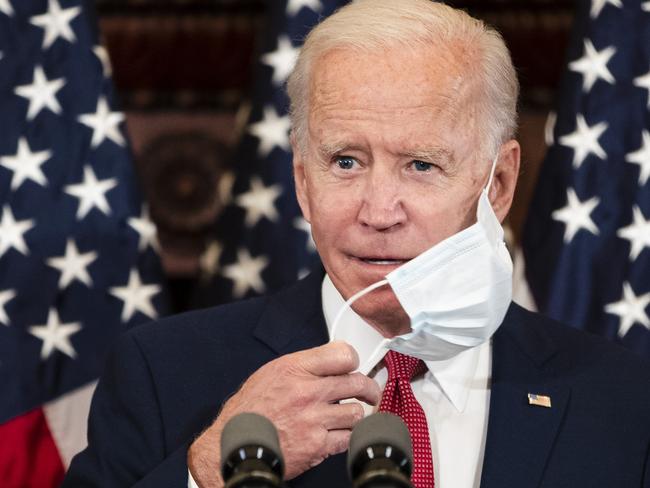 Joe Biden slips off his mask to make a point. Picture: AP