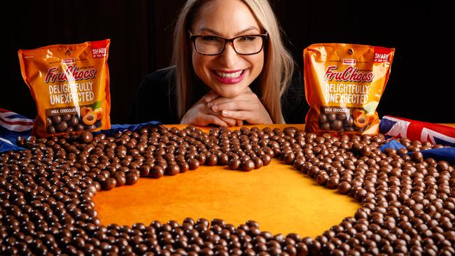 Polly Love with a giant map made of FruChocs. Picture: Matt Turner