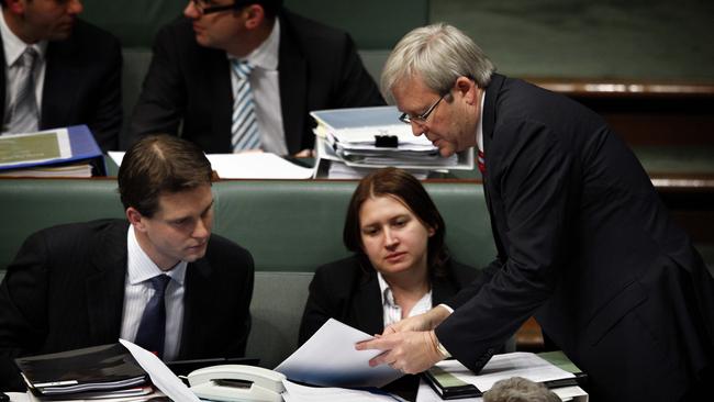 Then-prime minister Kevin Rudd confers with then-senior adviser Dr Charlton, left, in question time in question time. Picture: Ray Strange