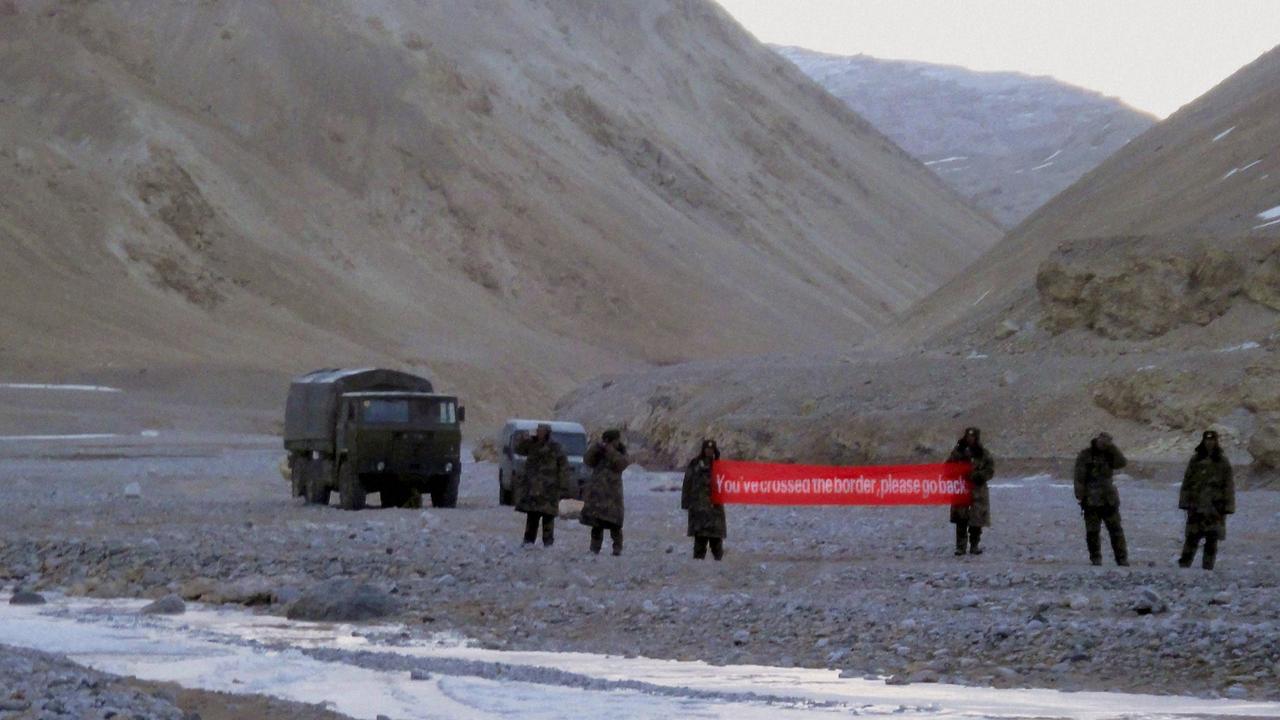 A 2013 image which shows Chinese troop holding a banner which reads, "You've crossed the border, please go back," in Ladakh, India. Picture: AP.