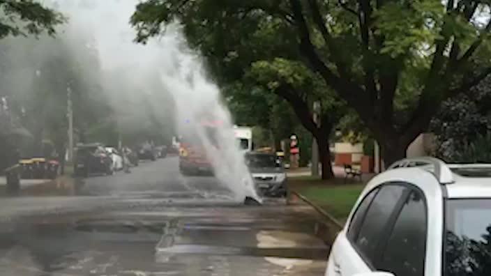 Burst water main floods street