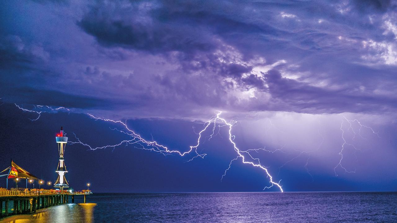 A lightning strike seen near Brighton Jetty in Adelaide, included in the 40th edition of the Australian Weather Calendar. Picture: Steven Genesin