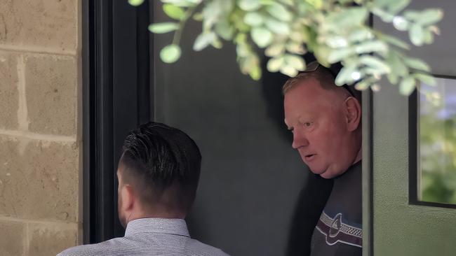 Murphy’s husband Mick Murphy talks to a Victoria Police missing persons unit officer on Wednesday this week. Picture: Luis Enrique Ascui