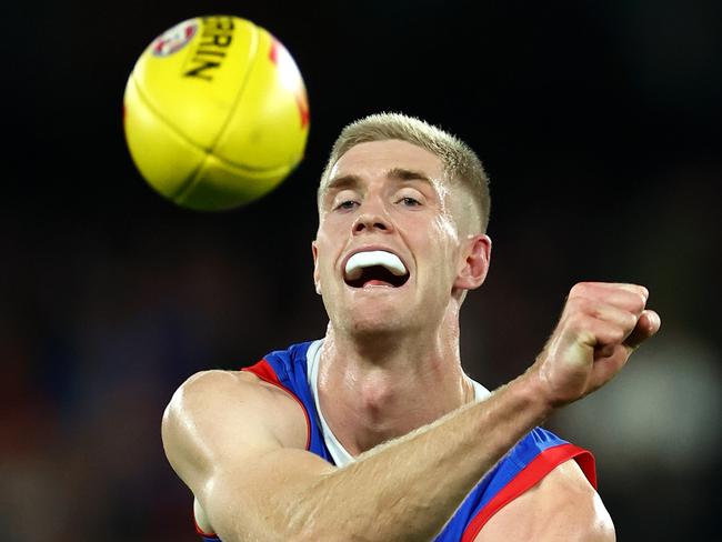 MELBOURNE, AUSTRALIA - APRIL 12: Tim English of the Bulldogs handballs during the round five AFL match between Western Bulldogs and Essendon Bombers at Marvel Stadium, on April 12, 2024, in Melbourne, Australia. (Photo by Quinn Rooney/Getty Images)