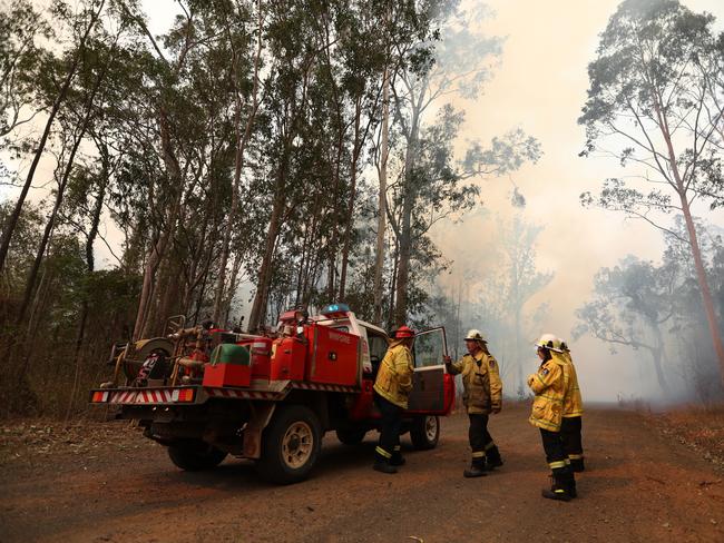 Firefighters battle bushfires in Busbys Flat, northern NSW, Wednesday, October 9, 2019. (AAP Image/Jason O'Brien)