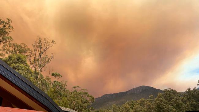 A dramatic smoke plume from the Gell River fire over kunanyi/Mt Wellington, taken from South Hobart. Picture: PETER GRANT