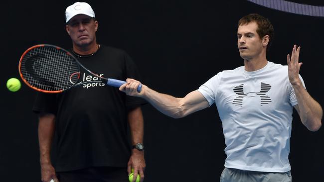 Andy Murray hits a return with coach Ivan Lendl looking on. Picture: AFP