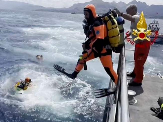 Divers enter the water off Porticello on the site where the luxury yacht Bayesian sank with 22 people on-board. Picture: AFP