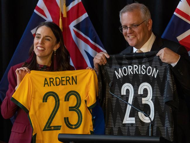 QUEENSTOWN, NEW ZEALAND - MAY 31: New Zealand Prime Minister Jacinda Ardern and Australian Prime Minister Scott Morrison hold up matching womans soccer world cup jerseys during the Australia-New Zealand Leaders Meeting on May 31, 2021 in Queenstown, New Zealand. Australian Prime Minister Scott Morrison is on a two-day visit to New Zealand to attend the annual Australia-New Zealand Leaders' Meeting. The trip is Scott Morrison's first overseas visit in 2021. (Photo by James Allan/Getty Images)