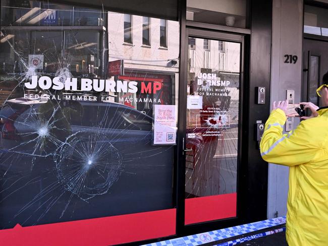 People pass the electoral office of Australian federal Labor Party member of parliament Josh Burns in the Melbourne suburb of St Kilda after police said at least five people smashed windows and painted slogans on the walls on June 19, 2024. It is the latest in a string of acts of vandalism targeting the offices of state and federal MPs in the wake of the conflict in Gaza. (Photo by William WEST / AFP)