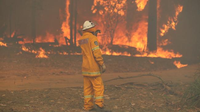 Fire and smoke at the small coastal town of Berrara, near Sussex Inlet on the NSW south coast on Saturday. Picture: David Swift.