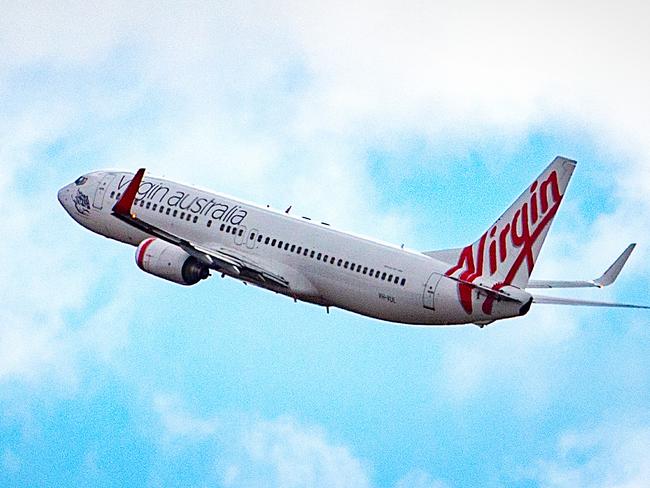 Virgin Australia says it is offering unlimited changes to flight bookings and is waiving any applicable change fees until January 31. Picture: NCA NewsWire / Sarah Matray