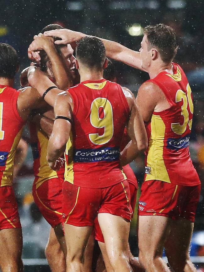 Action from the AFL match between the Gold Coast Suns and the North Melbourne Kangaroos, held at Cazalys Stadium, Cairns. Gold Coast players celebrate a goal. PICTURE: BRENDAN RADKE