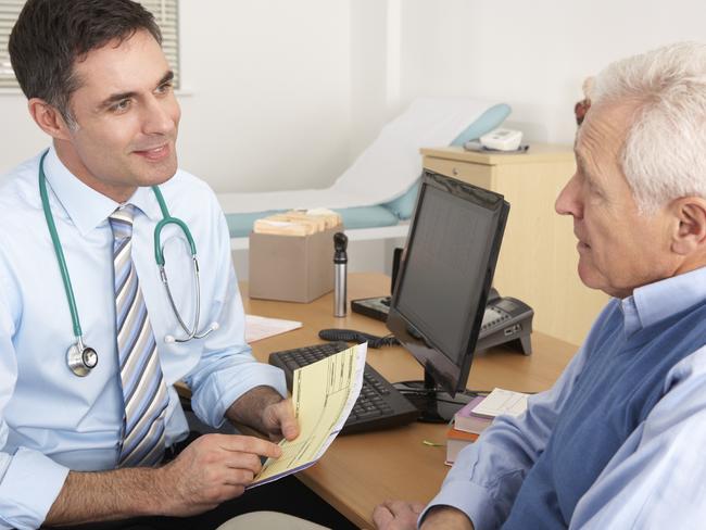 A doctor talking to senior man in surgery