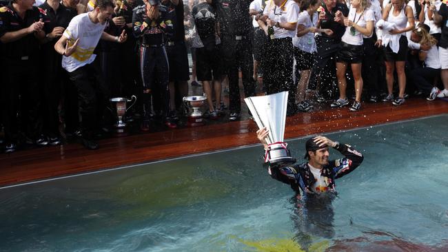 Webber in the pool with the trophy.