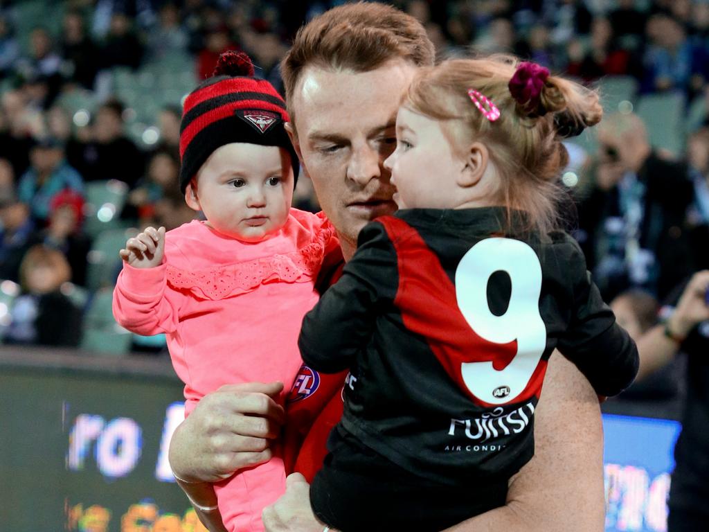 Brendon Goddard of the Bombers runs out with his kids at the start of the Round 23 AFL match between the Port Adelaide Power and the Essendon Bombers at Adelaide Oval in Adelaide, Friday, August 24, 2018. (AAP Image/Kelly Barnes) NO ARCHIVING, EDITORIAL USE ONLY