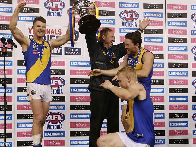 Ben Jolley and Andy Collins raise the 2015 premiership cup.