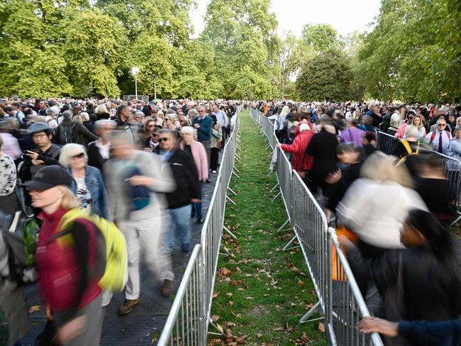 Members of the public stand in the queue as they wait in line to pay their respects to the late Queen Elizabeth II. Picture: AFP.