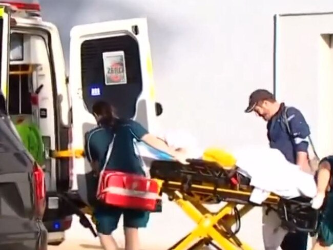 Paramedics transport a 13-year-old girl bitten by a shark at Bargara on Friday. Picture: 7News