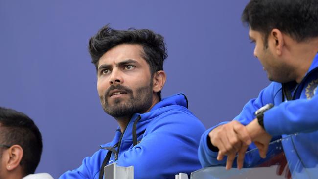 Ravindra Jadeja (C) look on from the Indian dressing room during the rain delay. Picture: Getty