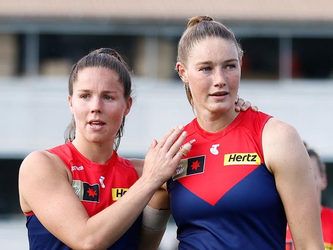 MELBOURNE, AUSTRALIA - NOVEMBER 12: Kate Hore (left) and Tayla Harris of the Demons look dejected after a loss during the 2023 AFLW Second Qualifying Final match between The Melbourne Demons and The North Melbourne Tasmanian Kangaroos at IKON Park on November 12, 2023 in Melbourne, Australia. (Photo by Michael Willson/AFL Photos via Getty Images)