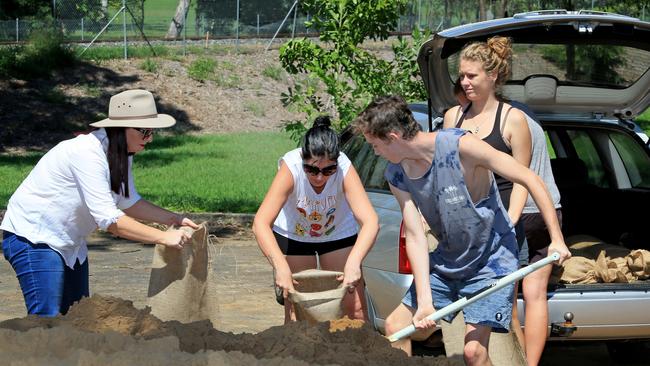 Member for Keppel Brittany Lauga with Emma Carter, Isaac Mobbs and Raelene Lappin, preparing sandbags. Picture: Tim Marsden