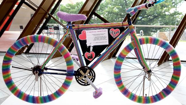 PM Malcolm Turnbull and his wife Lucy with Sydney-based yarn bomber known as ÔTreble MakerÕ  Eloise Murphy, with the Love Wheels bicycle she crocheted at the National Museum of Australia in Canberra. The iconic bike, gifted to the National Museum last year, was chained to a pole outside Prime Minister Malcolm TurnbullÕs Sydney home during the marriage equality postal vote campaign and featured on his and Lucy TurnbullÕs social media channels as they tracked down the artist.