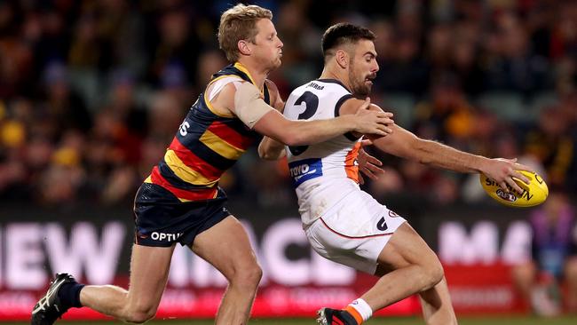 Rory Sloane tackles Stephen Coniglio. Picture: James Elsby/AFL Photos/Getty Images