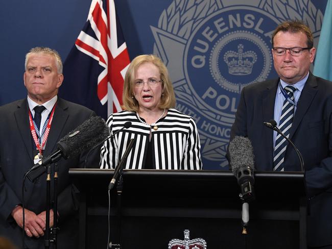 Queensland chief health officer Jeannette Young flanked by police. Picture: AAP Image/Dave Hunt