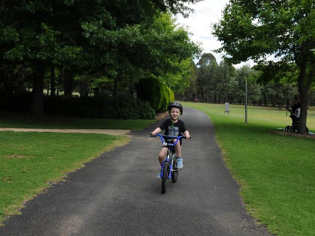 Ari Wilson, 5, of Castle Hill, takes his bike for a spin in Fagan Park, Galston.